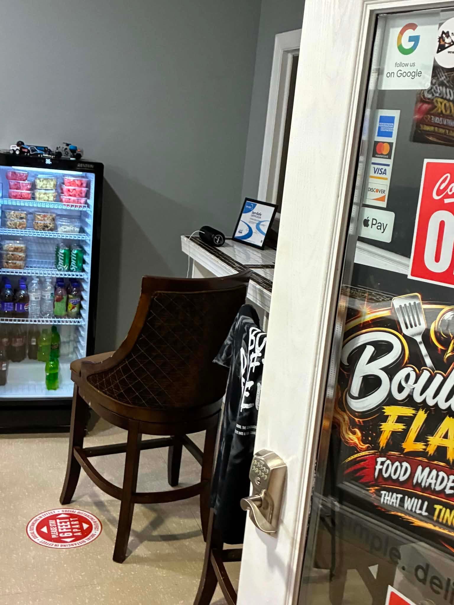 Inside Boulware's Flavor Café: the drinks cooler and the front door